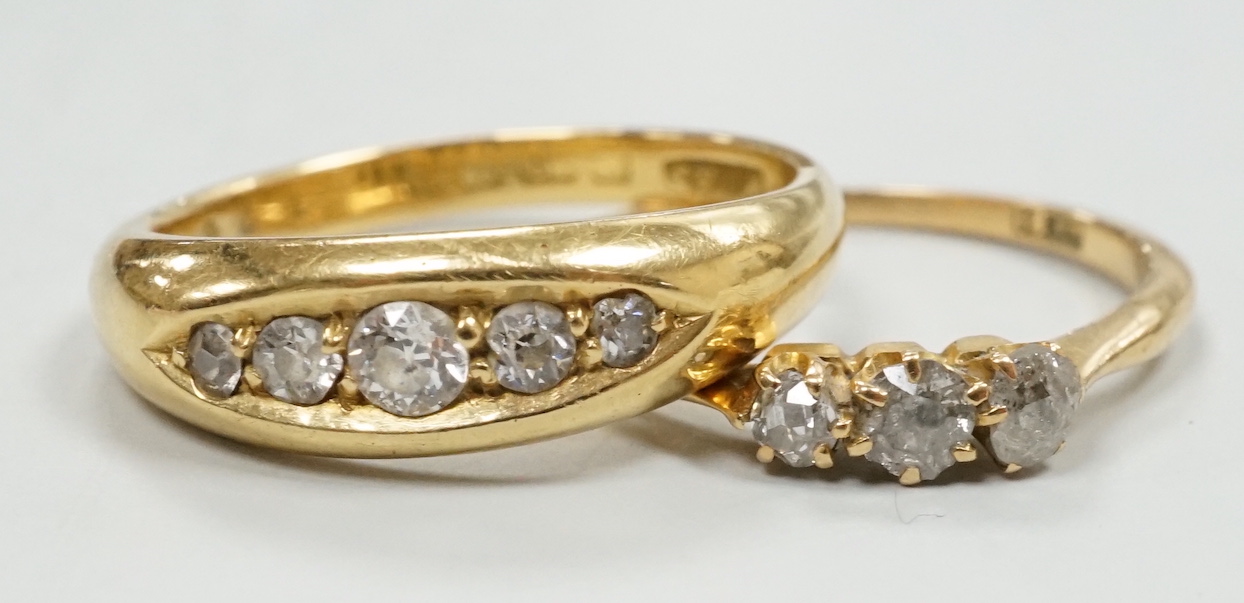 An Edwardian 18ct gold and graduated five stone diamond chip set ring, size P/Q and a small 18ct and three stone diamond ring, gross weight 7.3 grams.